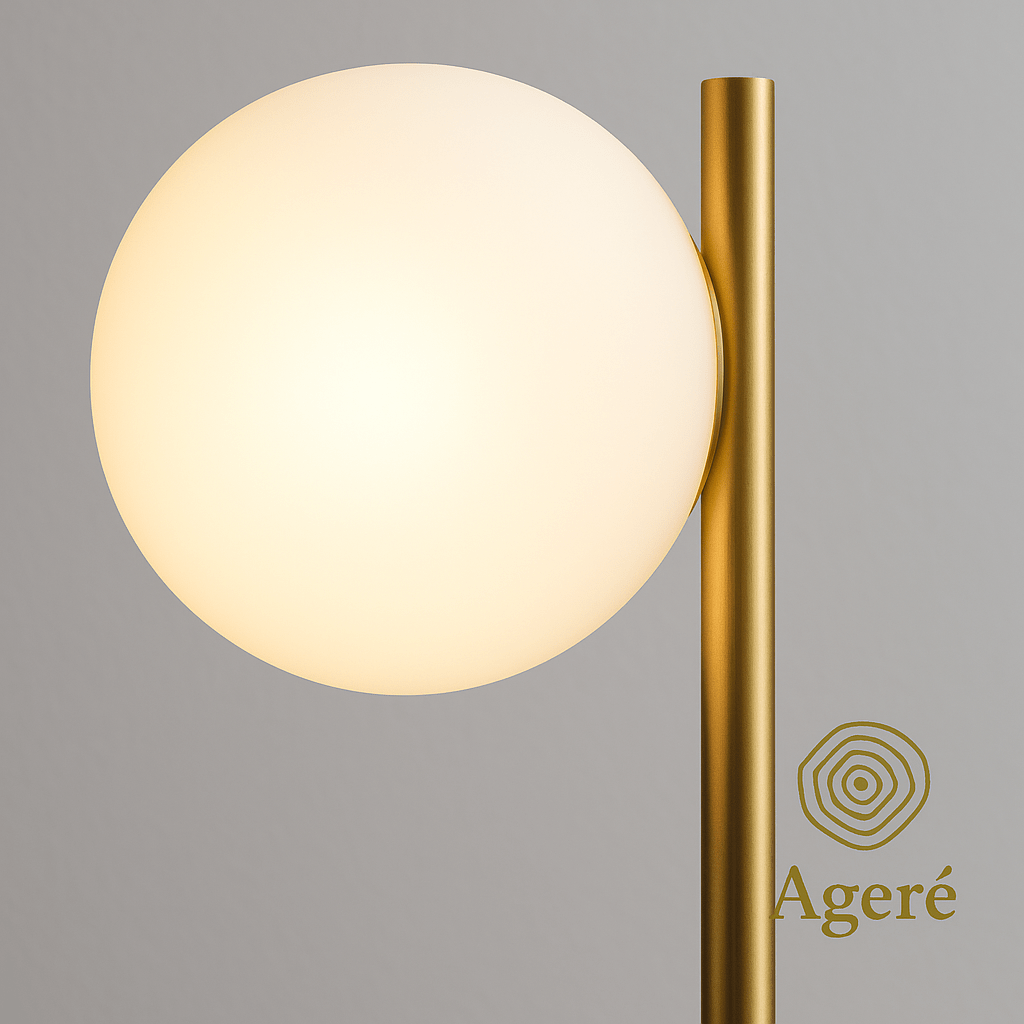 The Moon Lamp - Ageré Detailed shot of frosted globe that looks lika a mini moon and gold rod intersecting at the top